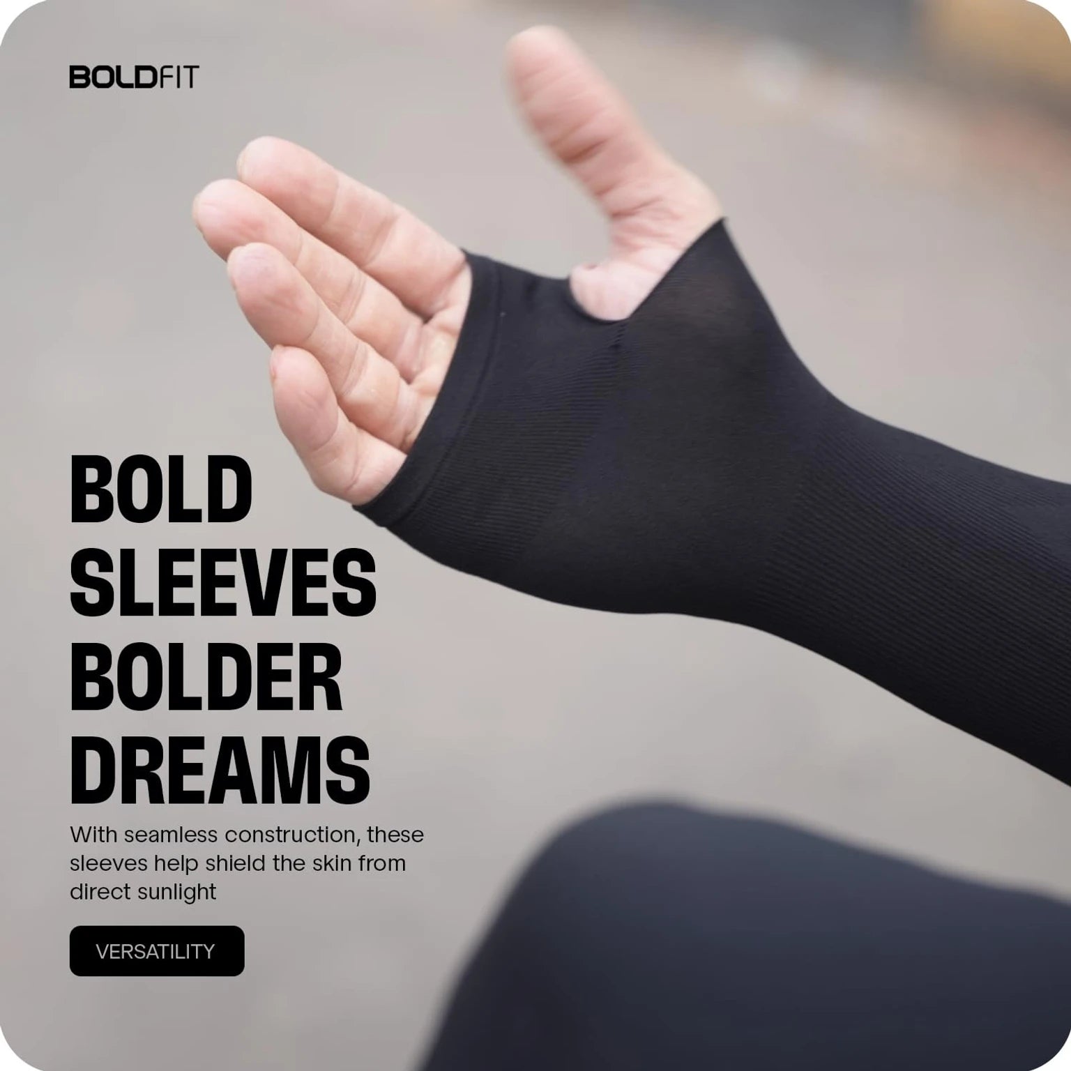 Black half-sleeve compression arm sleeve with thumb hole, worn on a forearm